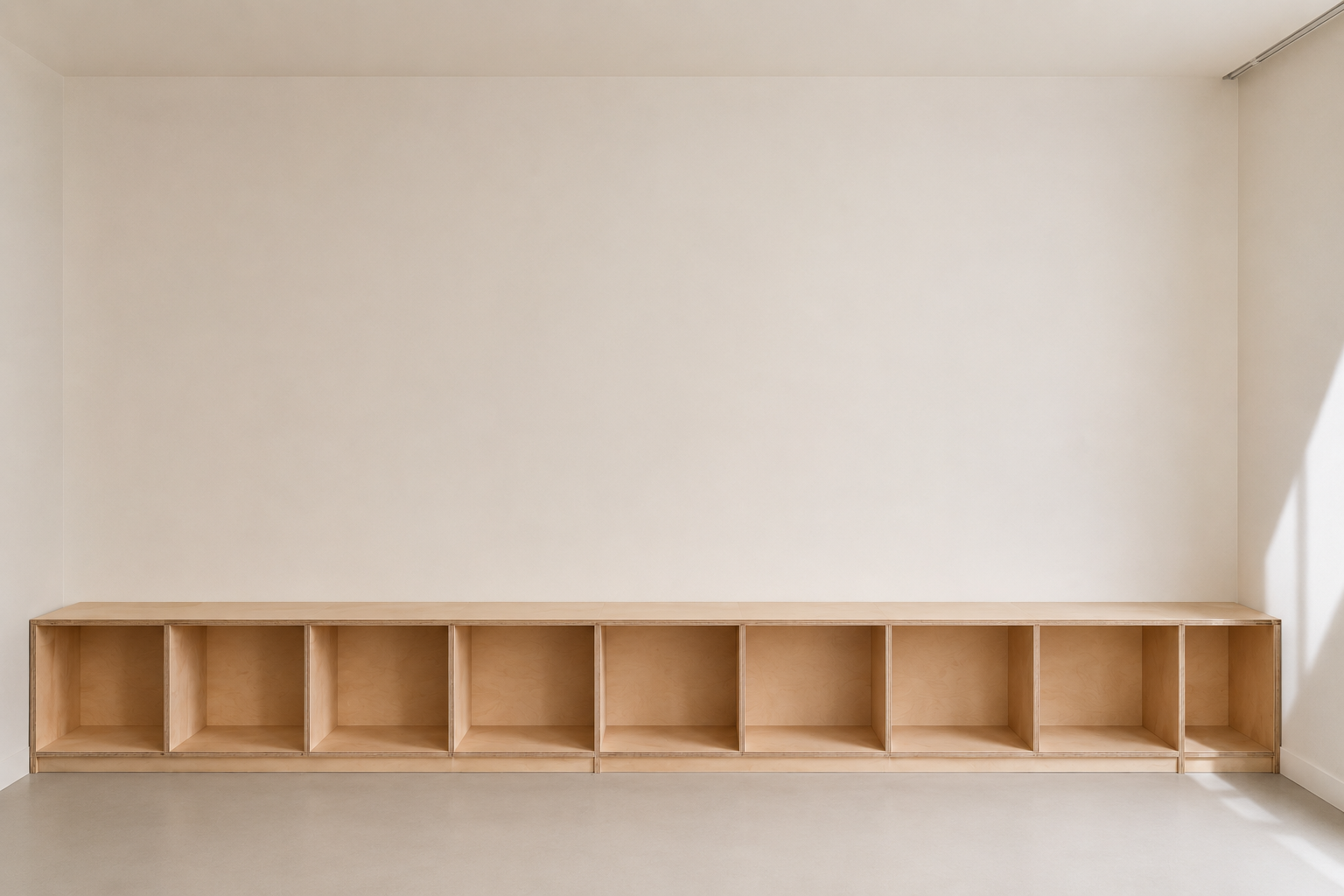 

Long open plywood cabinet fitted along a calm interior wall
